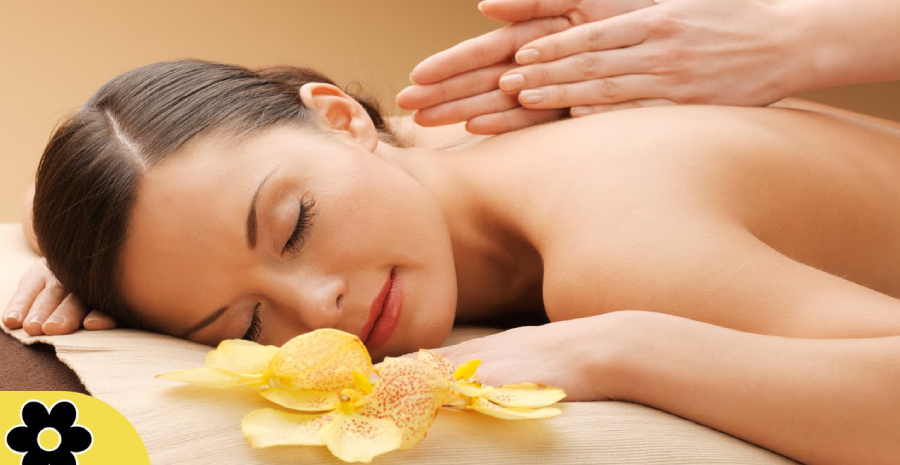 Woman Relaxing While Getting Back Massage By A Massage Therapist in a Renowned Massage Center.