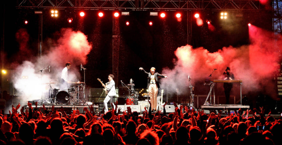 Image Showing A Rocking Performance of a pop singer with his musical band in a grand musical event.