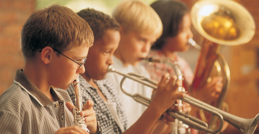 Group of Boys Playing Trumpet Instrument During A Musical Performance.