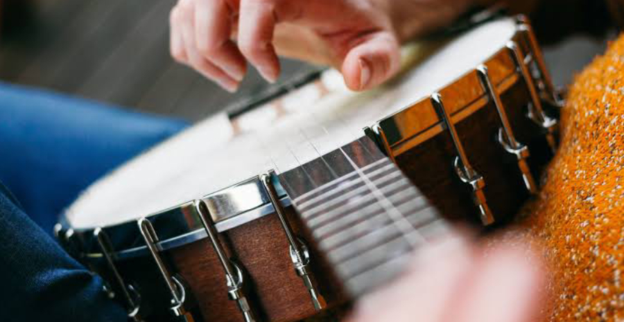 Close-up View of playing guitar by a girl.