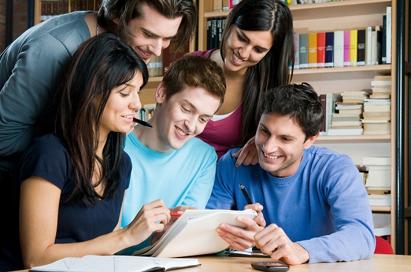 Happy Young University Students Studying With Books In Library Class. 